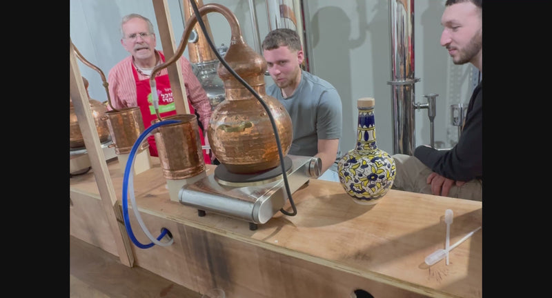Guests distilling their own gin at the copper still, Tavlin Distillery workshop